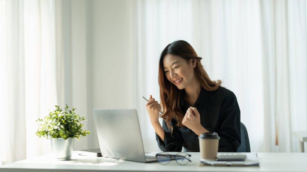 Woman smiling while using her laptop